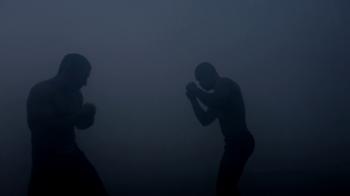 Boxers silhouettes starting to fight at dark ring. Boxing fight ...