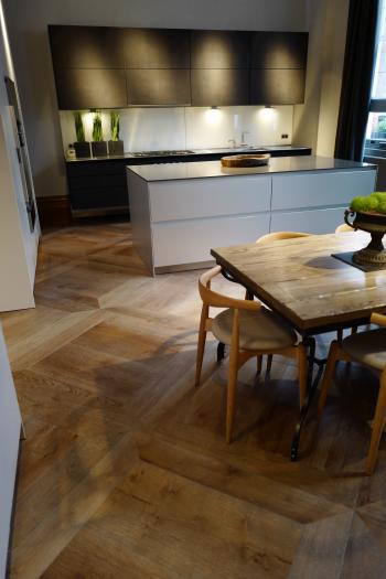 Antique grey distressed engineered flooring enhances this kitchen ...