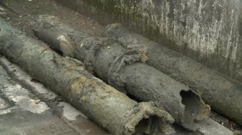 Broken and dirty water pipes on the road. Renovation of underground ...