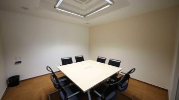 Empty small meeting room with table and chairs in modern building ...