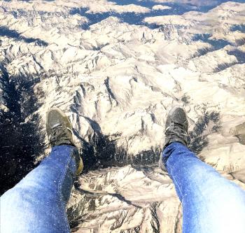 Feet hanging over the Alps