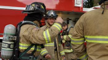 Firemen next to fire truck getting gear on Stock Video Footage ...