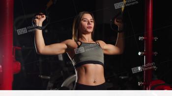 Young Fit Woman Doing Pull-ups On Gymnastic Rings. Muscular Young ...