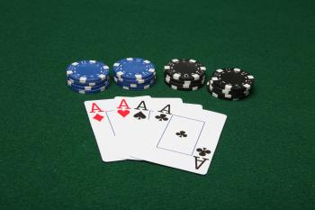 Four of a kind aces with poker chips