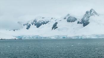 Freezing Cold Antarctica with Tall Ice Covered Mountains and Moving ...