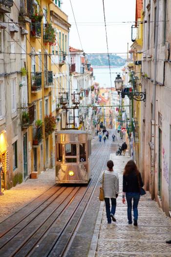 Elevador da Bica funicular on a steep cobbled street in Lisbon ...