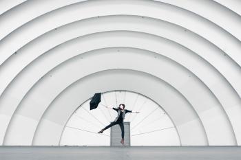 Girl Jumping While Holding Umbrella