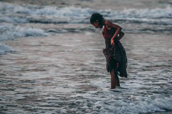 Girl Standing on Seashore