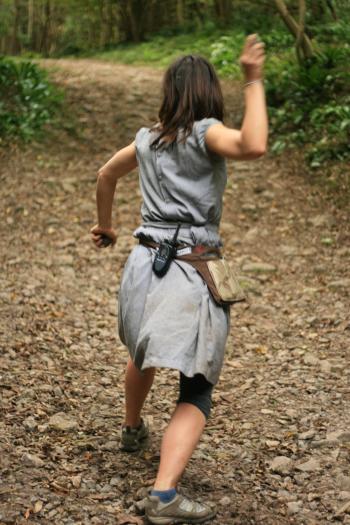 This picture depicts a lady in ragged clothes throwing stones at ...