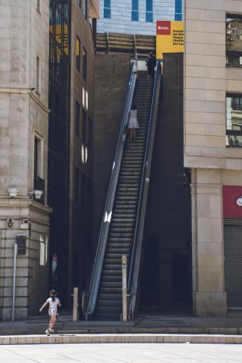 Girl Walking Towards the Escalator