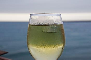 Glass of white wine on the beach
