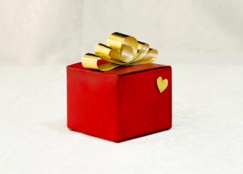 Golden ribbon bow on a gift red box