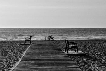 Grayscale Photo of Bicycle Beside Seashore