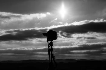 Grayscale Photo Of Camera Under The Sun