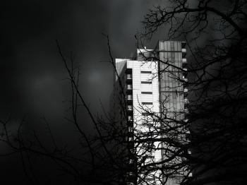 Grayscale Photo of Concrete High Rise Building
