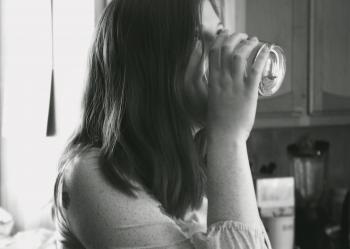 Grayscale Photo of Lady Drinking Water