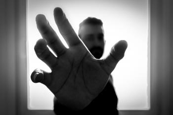 Grayscale Photo of Man Grabbing Using Right Hand