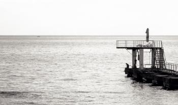 Grayscale Photo of Sea Diving Port