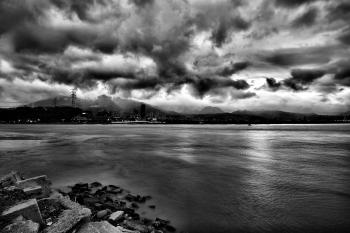 Grayscale Photo of Sea during Cloudy Sky at Daytime