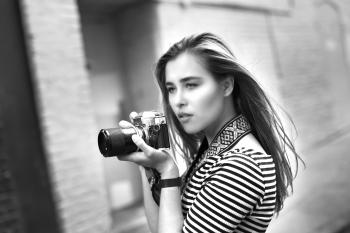 Grayscale Photo of Woman Holding a Dslr Camera