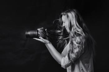 Grayscale Photo of Woman Using Dslr Camera