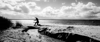 Grayscale Photography of a Person Jumping over Body of Water