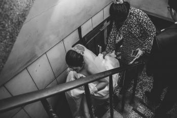 Grayscale Photography of Bride on Stair
