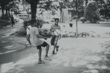 Grayscale Photography Of Kids Playing Ball