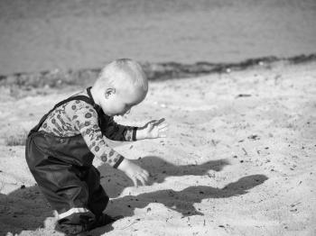 Grayscale Photography Of Toddler On Beach Sand