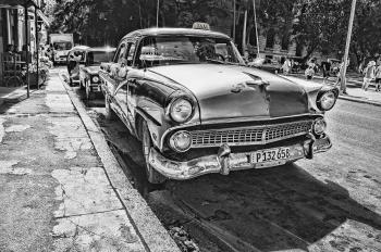 Grayscale Photography of Vintage Car Beside Pavement