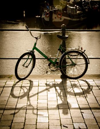 Green Bike Parked Beside the Body of Water