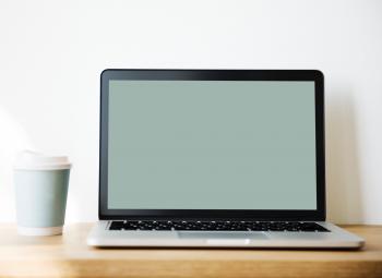 Grey and Black Laptop Beside White and Teal Coffee Cup