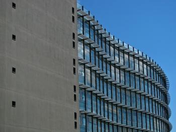 Grey Concrete Building With Blue Windows