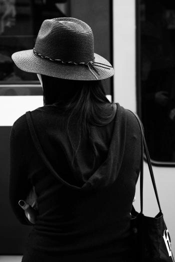 Greyscale Photo of a Woman Wearing a Hat