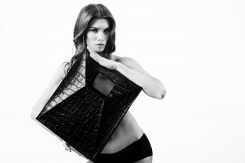 Greyscale Photography of Woman Holding Leather Square Covering Her Upper Body