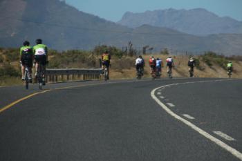 Group of bikers on the road behind the mountains