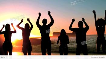 Group Of Friends Jumping On The Beach Under The Du Stock video ...