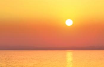 Hazy Sunset Over a Calm Sea - Summer Holidays