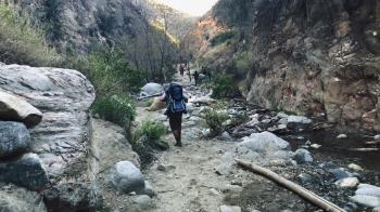 People hiking through rocks on mountain ~ Hi Res #88060121