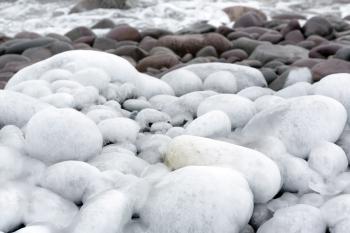 Ice Covered Rocks on a Beach