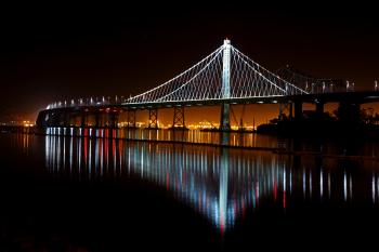 Illuminated Suspension Bridge Against Sky at Night