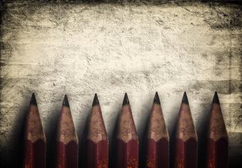 Illustration of vintage style red pencils over rough background