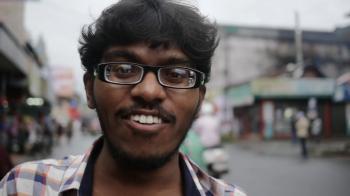 Young intelligent indian man walking on street in slow motion Stock ...