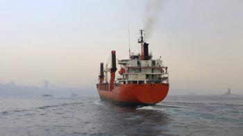 Cargo ship sailing in mist. Tracking shot of the industrial ship ...