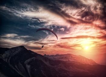 Into the atmosphere - Paragliding over mountain ridge