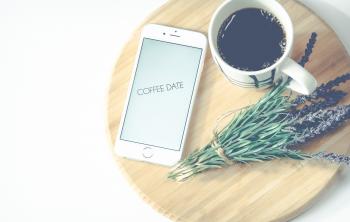 Iphone Beside Coffee And Flower