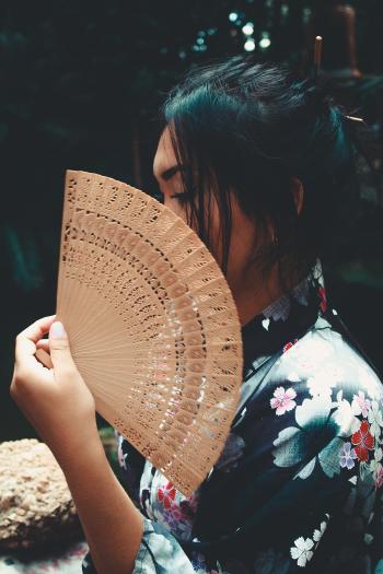 Japanese Woman Holding Brown Hand Fan