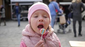 Child Girl Portrait Lick A Sweet Candy Lollipop On A Stick At Food ...