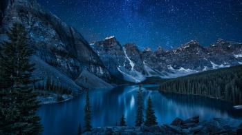 Moraine Lake at night, snowy landscape in the mountains, Canada ...