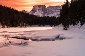 Landscape Photography Of Body Of Water Covered With Snow And Surrounded With Trees And Mountain